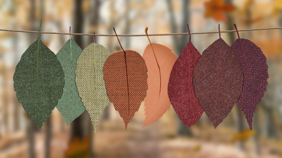 Leaves made from different fabric hung in a row from a rope.