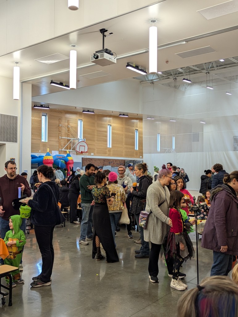 Attendees stand and chat during the Harvest Festival.
