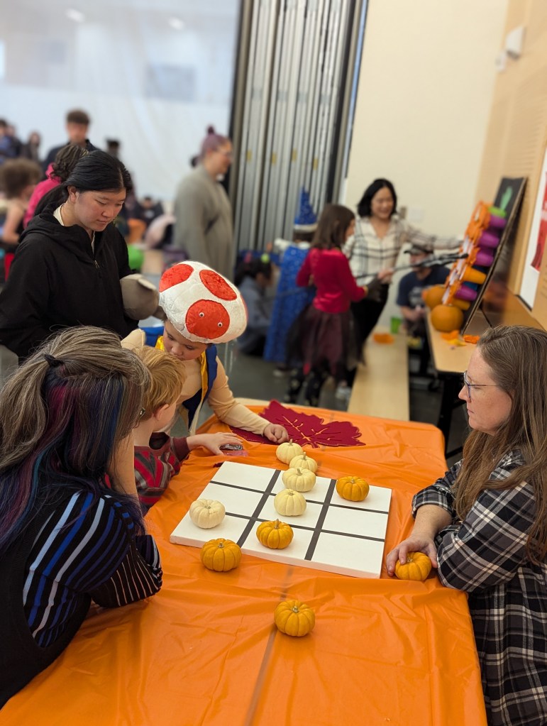 Students play tic-tac-toe with mini pumpkins