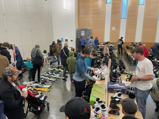 Shoppers looking at ski and snowboarding equipment.
