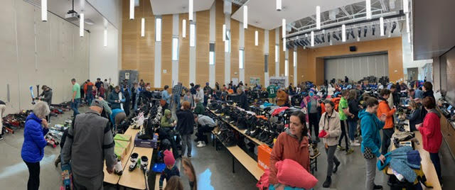 A panoramic photo of the cafeteria with shoppers looking at winter items.