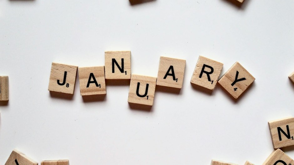 Wooden Scrabble letters arranged to spell January