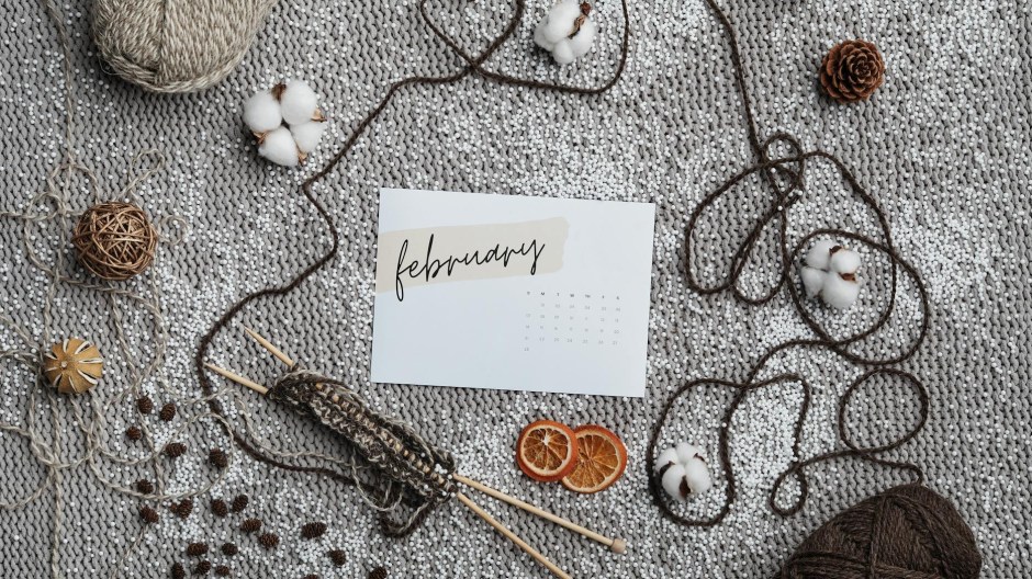 Paper February Calendar laying next to knitting supplies.