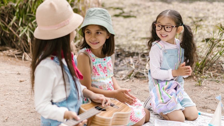 Three elementary school girls sitting and chatting.