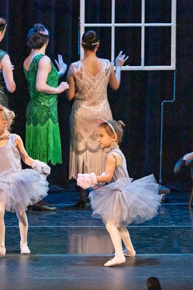 Calypso on stage dressed in a grey tutu with mouse ears.