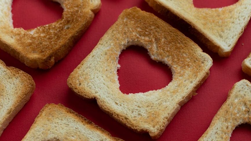 Heart shape cut out in the middle of toast.